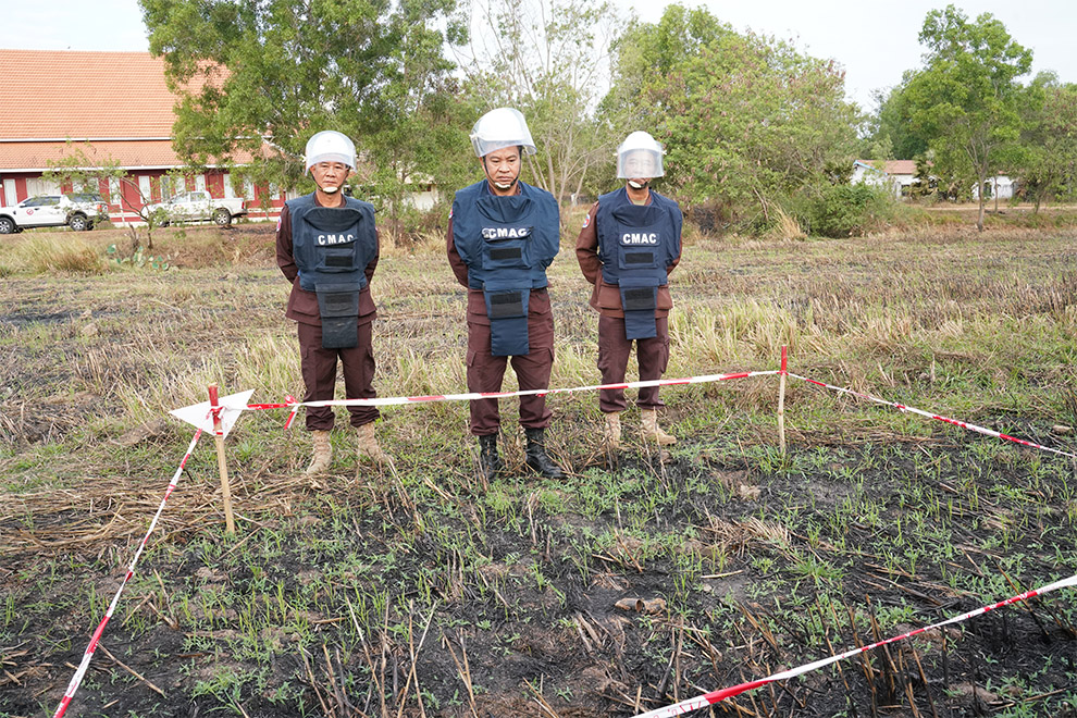 Brigadier General Neth Ratha, head of Demining Unit 1 of the Cambodian Mine Action Centre (CMAC) (middle) speaks to the media on February 4 at the site of unexploded cluster munitions near the O’Chrov district office. Hong Raksmey