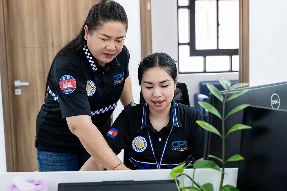 (from left) CPU assistant director of Child Protection Services, Som Vathna, supports CPO Lida on a case. Supplied