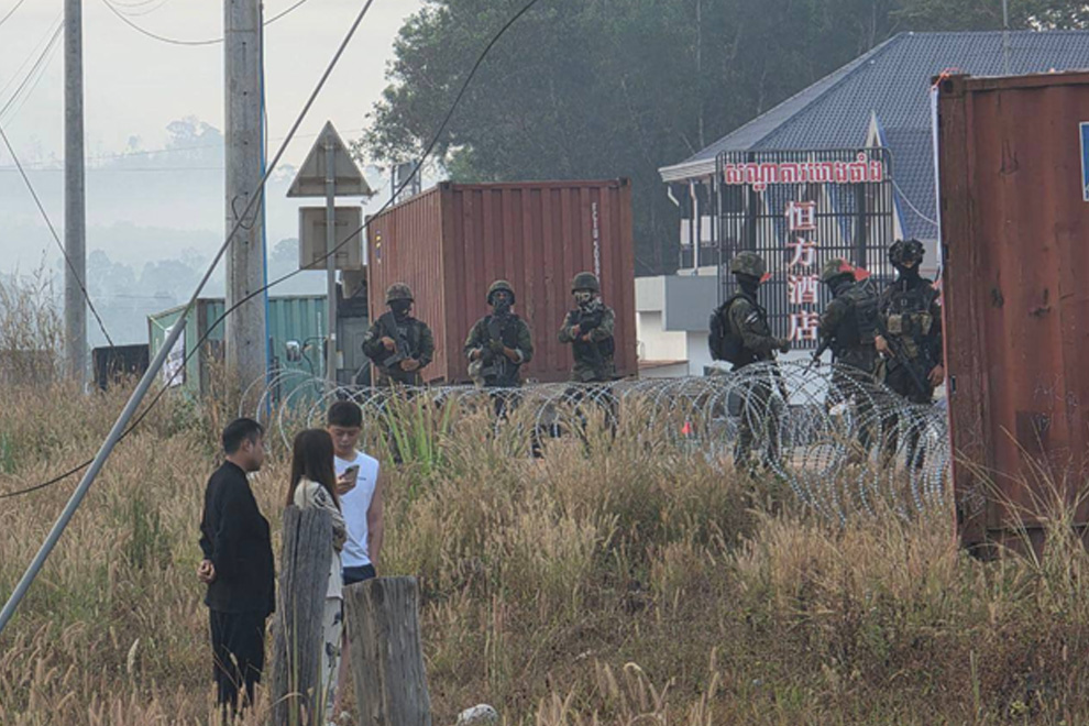 Thai soldiers stand guard near the shipping container barriers that they placed on Cambodian soil, this morning, February 7. Supplied