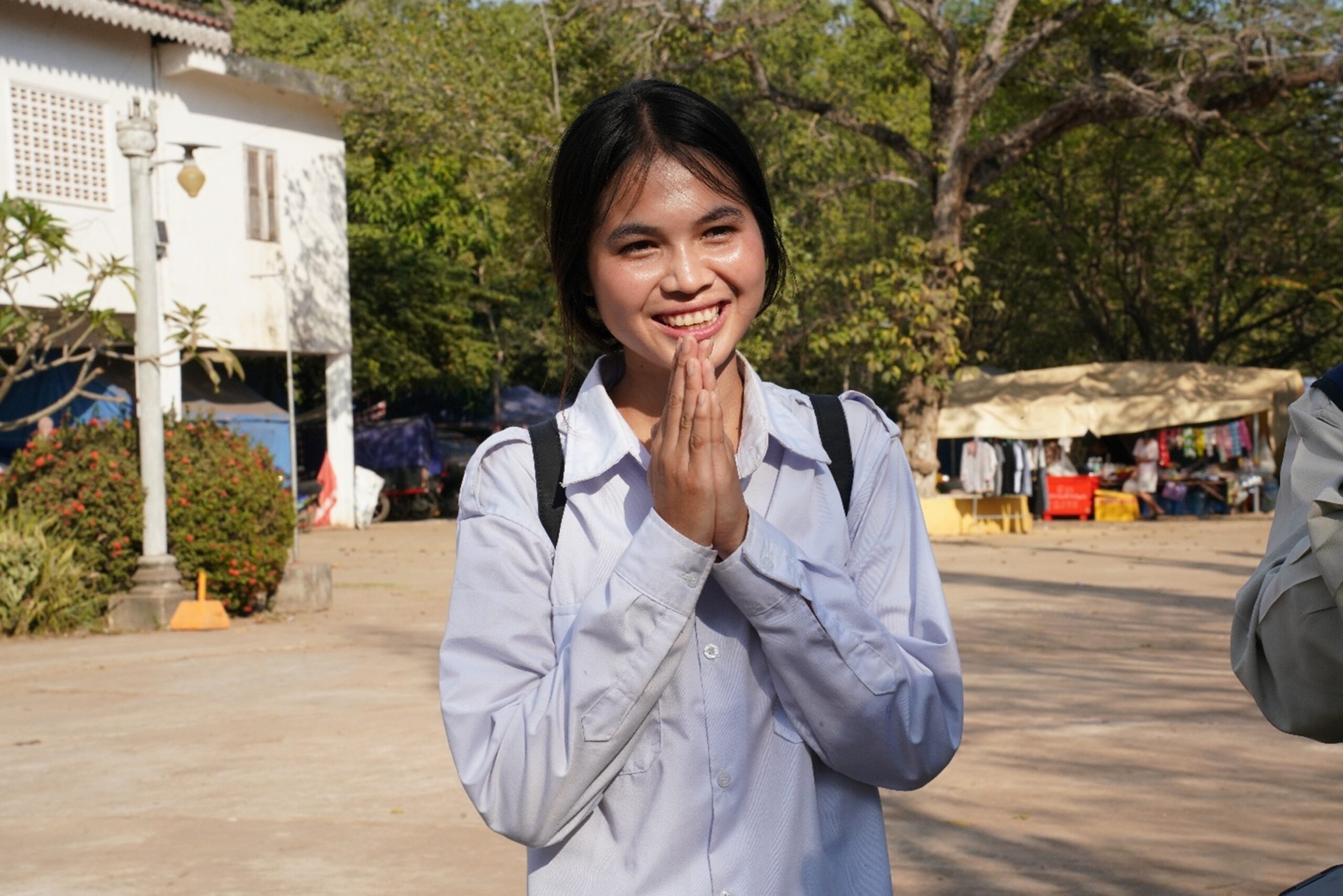 Doen Sna, principal of Wat Kork Prasat Primary School, looks at a backpack that was left behind by a student fleeing Thai shelling. Hong Raksmey 